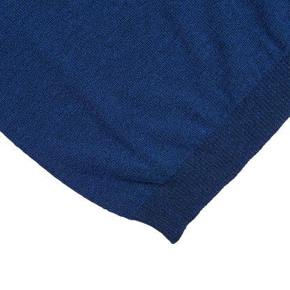 A close up of a Denim Blue Cotton Mouline 1/4 Zip Sweater by Maurizio Baldassari on a white surface.