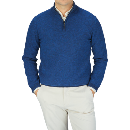 A man wearing a Maurizio Baldassari Denim Blue Cotton Mouline 1/4 Zip Sweater and khaki pants.