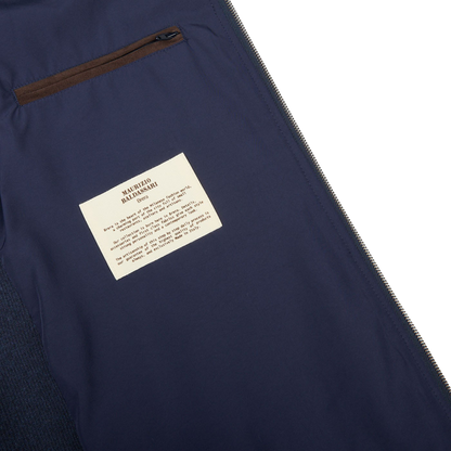 A Maurizio Baldassari Denim Blue Water Repellent Pure Cashmere Gilet with a label on it.
