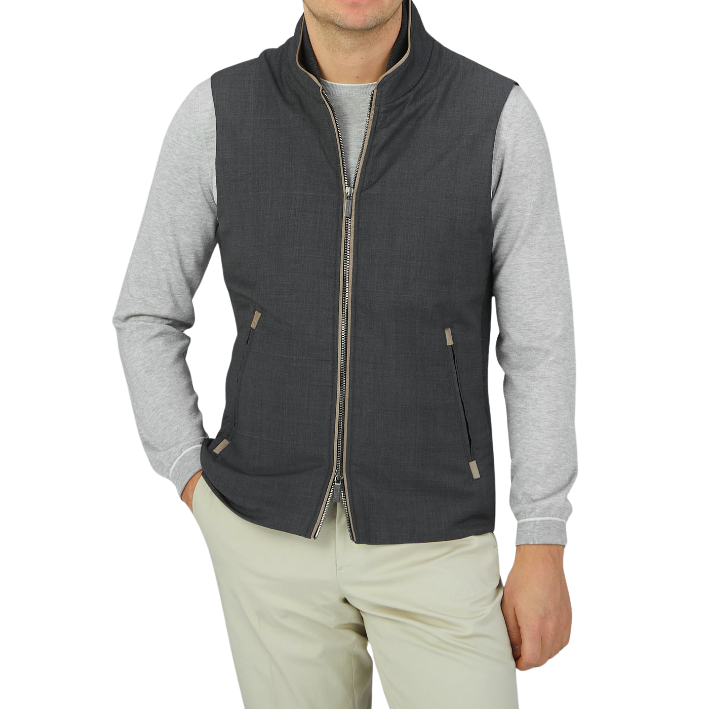 A man donning a Maurizio Baldassari Charcoal Grey Merino Wool Travel Gilet and khaki pants.
