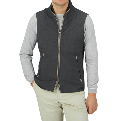 A man donning a Maurizio Baldassari Charcoal Grey Merino Wool Travel Gilet and khaki pants.