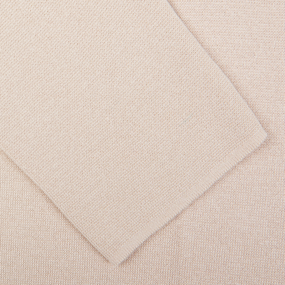 Close-up view of two textured fabric samples overlapping each other, one being a silk-cotton blend in the Maurizio Baldassari Light Beige Silk Cotton Knitted Milano Blazer.