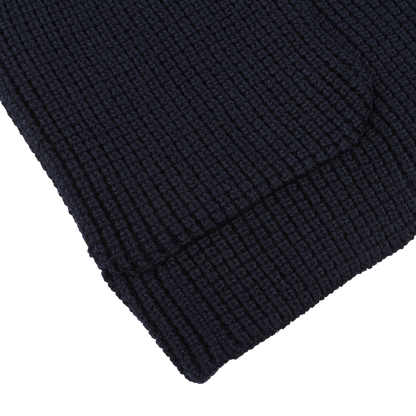 Close-up of the Navy Blue Zegna Baruffa Wool Brenta Jacket by Maurizio Baldassari, highlighting its expertly knitted fabric with a textured pattern that showcases exceptional craftsmanship in every stitch, suggesting the timeless quality of this high-end garment.