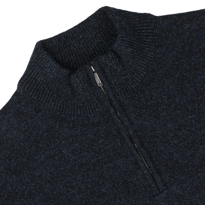 A close-up image of the Maurizio Baldassari Navy Winter Wool Mouline 1/4 Zip Sweater, crafted from soft Tasmanian wool in a navy blue melange, featuring a ribbed collar and partially open zipper.