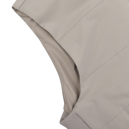 Close-up of the Maurizio Baldassari Pale Beige Nylon Thermore Travel Gilet, highlighting armhole and seam details against a black background.