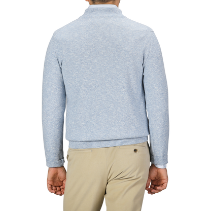 A man is seen from behind wearing a Sky Blue Winter Wool Mouline 1/4 Zip Sweater by Maurizio Baldassari and beige pants.
