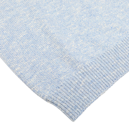 Close-up of the Sky Blue Winter Wool Mouline 1/4 Zip Sweater by Maurizio Baldassari, highlighting the texture and pattern of the melange knitted fabric.