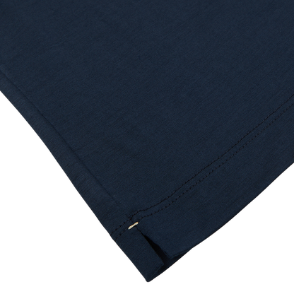 Close-up of a Mazzarelli navy blue Merino wool t-shirt with detailed stitching and a small safety pin on the edge.