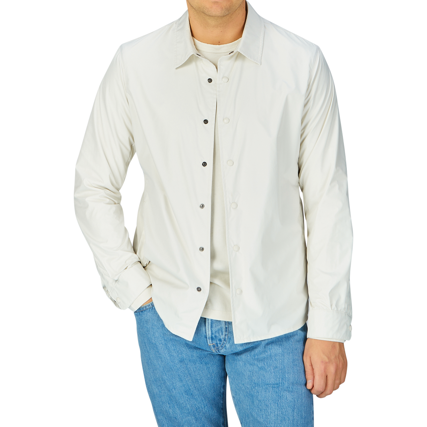 Man wearing a Mazzarelli water-resistant nylon, slim fit technical overshirt with white button-up shirt and blue jeans.