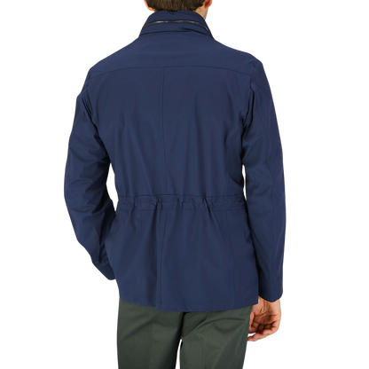 The back view of a man wearing a Dark Blue Lightweight Nylon Field Jacket by Moorer.