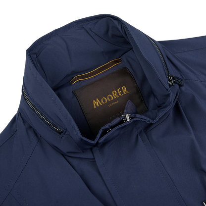 A Dark Blue Lightweight Nylon field jacket with the word Moorer on the back.