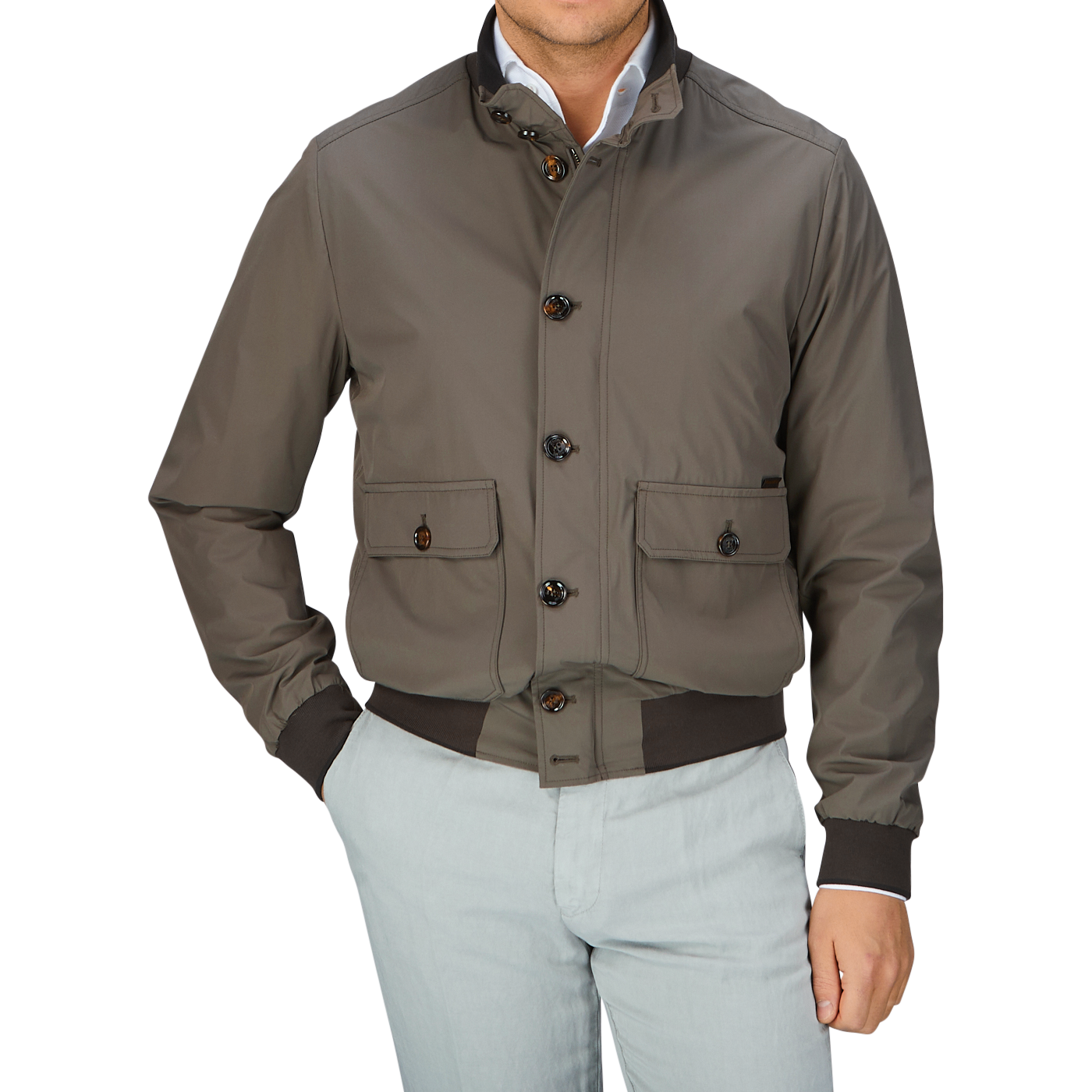 Man wearing a luxurious, olive green Moorer Technical Nylon Blouson with button detail over a light-colored shirt and pale pants.