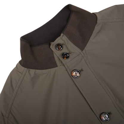 Close-up of a luxurious Olive Green Technical Nylon Blouson jacket collar with buttons by Moorer.