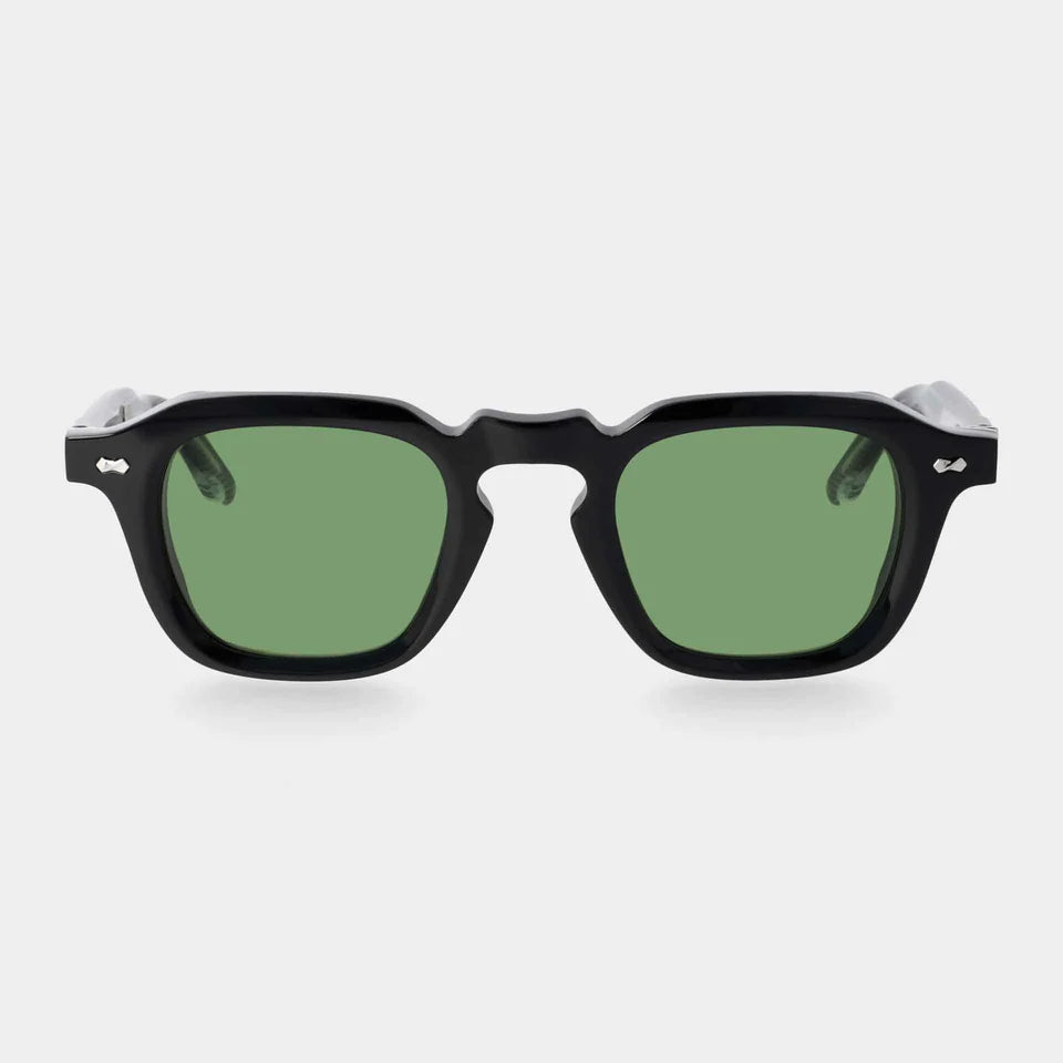 Front view of TBD Eyewear Ply Black | Green sunglasses with thick black rims, bold geometric design, green lenses, wide temples, silver rivets by the hinges, and a keyhole bridge. Handcrafted in Italy. , available at Richard Gelding Mayfair