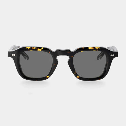 Front view of TBD Eyewear's Ply Black Havana | Grey sunglasses with thick, dark tortoiseshell frames and opaque grey lenses. Handcrafted in Italy, set against a plain light gray background for a bold, stylish look. , available at Richard Gelding Mayfair