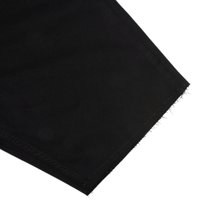 Close-up of a contemporary black Paige Black Shadow Cotton Stretch Federal shorts edge with unfinished, frayed hem in Transcend fabric.