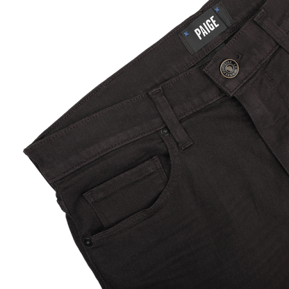 The Brown Cotton Transcend Normandie Jeans by Paige showcase a straight leg and regular fit, complete with a noticeable PAIGE label near the waistband and a button closure. Made from Transcend fabric, they offer enhanced comfort.