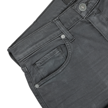 Close-up of the waistband and pockets of Paige's Charcoal Cotton Transcend Federal Slim Jeans, showcasing the stitching, button, and belt loops against a plain background. Experience the comfortable fit and durability with Transcend fabric.
