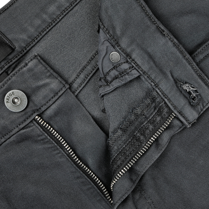 Close-up view of a partially unzipped pair of Charcoal Cotton Transcend Federal Slim Jeans by Paige, revealing intricate stitching and button details, crafted from Transcend fabric for a comfortable fit.