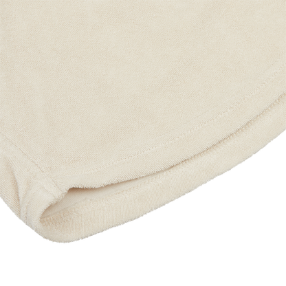 Close-up view of the hem of a Paige Cream Beige Cotton Towelling Polo Shirt on a white background.