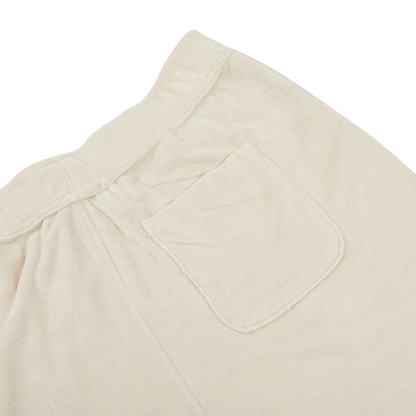 Close-up of the back pocket and waistband area of a pair of Paige Cream Beige Cotton Towelling Shorts, showing the fabric texture, stitching details, and a comfortable drawstring waist.