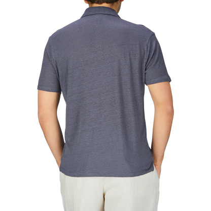 The man is wearing a breathable Grey Blue Linen Capri Collar polo shirt by Paige.