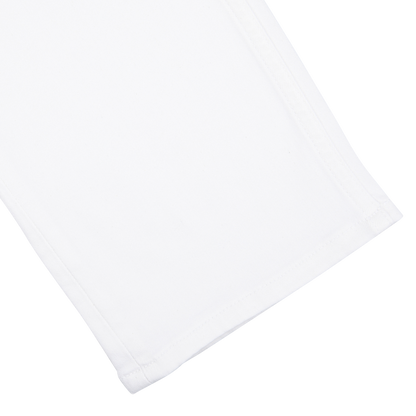 Close-up of a folded Icecap White Cotton Transcend Federal Slim Jeans by Paige on a white background.