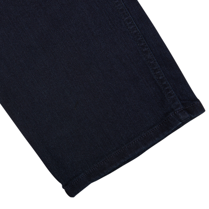 A close-up of a Paige Inkwell Blue Cotton Transcend Normandie Jeans with a visible seam and hem,possibly a part of regular fit jeans.