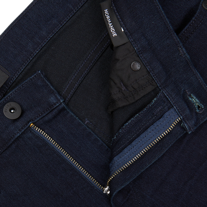 Dark Paige Transcend Normandie blue jeans with zipper fly and waistband button fastened, showcasing the brand label "normandie".