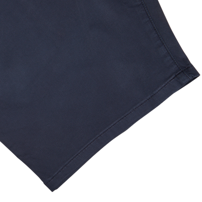 Close-up of a Paige Navy Blue Cotton Blend Phillips Shorts fabric with stitched hem on a white background.