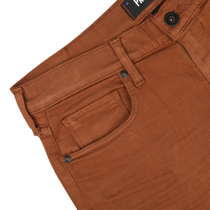 Close-up image of the waistband and pockets of Paige's Rust Brown Cotton Transcend Federal Slim Jeans on a white background. These comfortable fit pants feature a button and a visible brand label near the waistband.