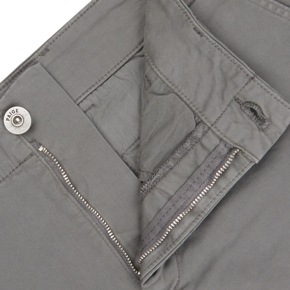 Close-up of a slate grey Paige Phillips jacket with a visible zipper pocket, stitched details, and a button closure, crafted from cotton blend.