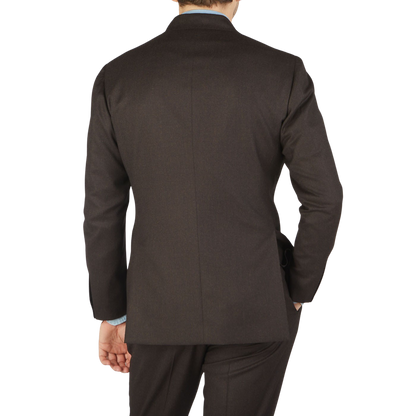 The back view of a man in a Ring Jacket Dark Brown Wool Flannel DB Suit.