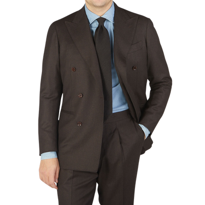A man in a Ring Jacket Dark Brown Wool Flannel DB Suit is posing for a photo.