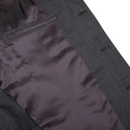 Close-up of a Ring Jacket Dark Grey High Twist Wool Suit jacket crafted from wool fresco fabric, with detail of inner lining and pockets, displayed on a white background.