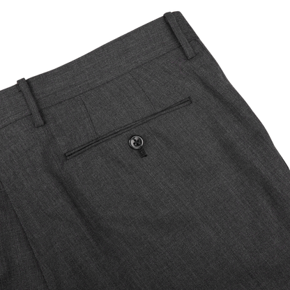 Close-up view of a Ring Jacket dark grey high twist wool suit waistband featuring belt loops and a buttoned rear pocket.