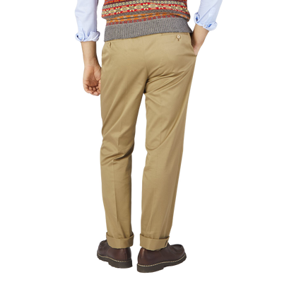 A man wearing a Ring Jacket sweater and Ring Jacket Khaki Beige Cotton Twill Pleated Trousers.