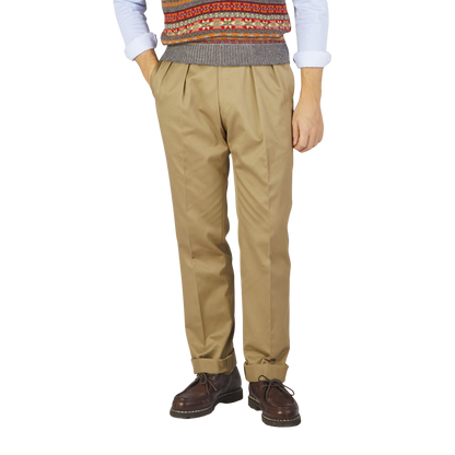 A man wearing Ring Jacket Khaki Beige Cotton Twill Pleated Trousers.
