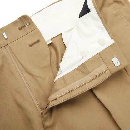 A pair of Ring Jacket khaki beige cotton twill pleated trousers with a white pocket.