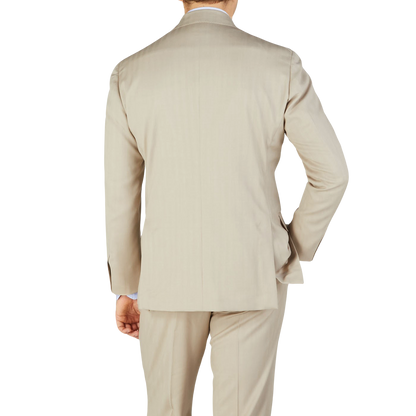 The back view of a man wearing a Ring Jacket Light Beige Herringbone Wool Suit.