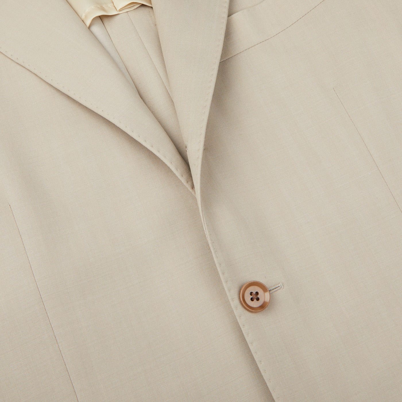 A close up of a Light Beige Herringbone Wool Suit by Ring Jacket.