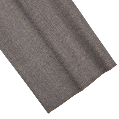 Folded Mid Grey High-Twist Wool Suit fabric from Ring Jacket on a patterned background.