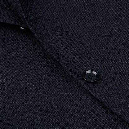 Close-up of a Ring Jacket Navy Blue Wool Balloon Travel Blazer featuring a detailed view of a button and fabric texture.