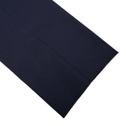 Close-up of a Ring Jacket navy blue high twist wool suit fabric with a raw, frayed edge against a white background.