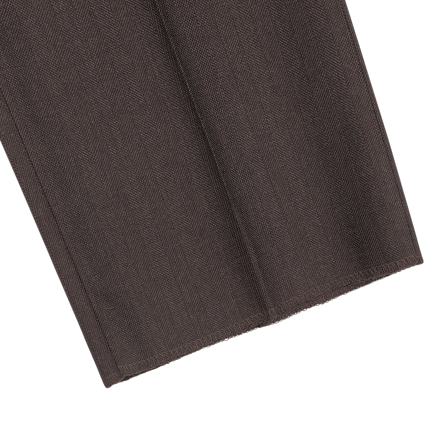 Close-up of the hem of a Brown Herringbone Calm Twist Wool Suit pant by Ring Jacket, highlighting the meticulous stitching line and the textured wool fabric.