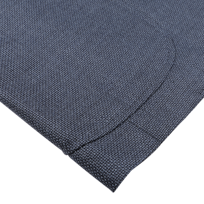Close-up of a folded Denim Blue Wool Balloon Travel Blazer by Ring Jacket, showcasing its textured fabric against a light gray background.