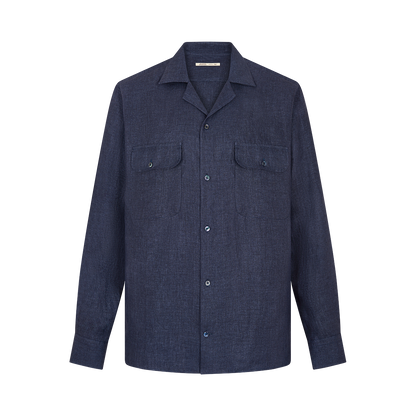 The Maurizio Baldassari Denim Blue Linen Army Shirt is a long-sleeved button-up with a straight collar and two buttoned chest pockets, featuring a clean design and shown against a plain white background. , available at Richard Gelding Mayfair