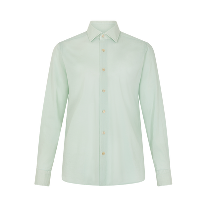 The Alessandro Gherardi Sage Stretch Cotton Panamino Beach Shirt features a pale mint green color, classic collar, long sleeves, and pearl buttons. , available at Richard Gelding Mayfair