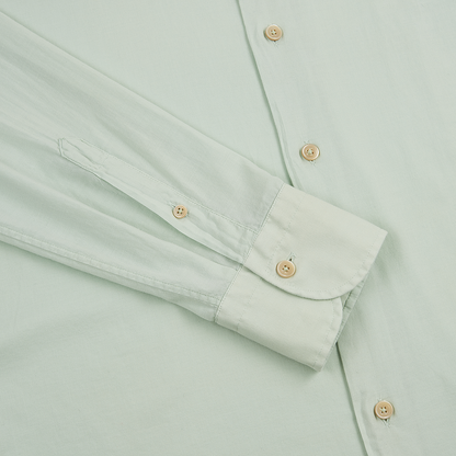 The Alessandro Gherardi Sage Stretch Cotton Panamino Beach Shirt is shown laid flat, with a close-up on the sleeve and side to highlight its beige cuff and front placket buttons. The smooth, slightly shiny fabric is clearly visible. , available at Richard Gelding Mayfair