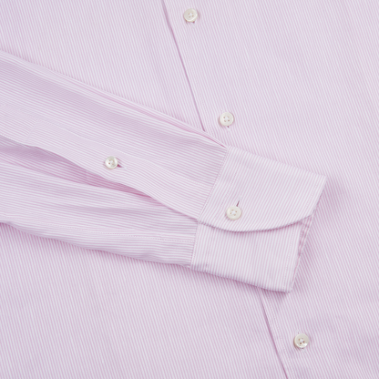 A close-up of the Stenströms Light Pink Stripe Cotton/Linen Shirt, neatly laid flat, highlights the long sleeve with a double-button cuff, front placket, white buttons, and fine vertical stripes. , available at Richard Gelding Mayfair